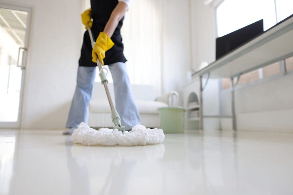 Person mopping clean white floor.